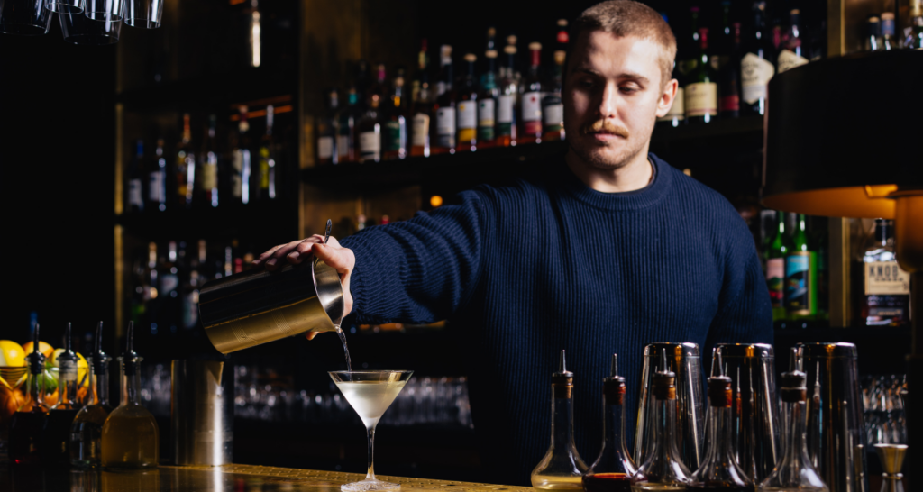 Bar tender pouring the Hawksmoor Dawn & Dusk Martini at Hawksmoor Chicago River North.