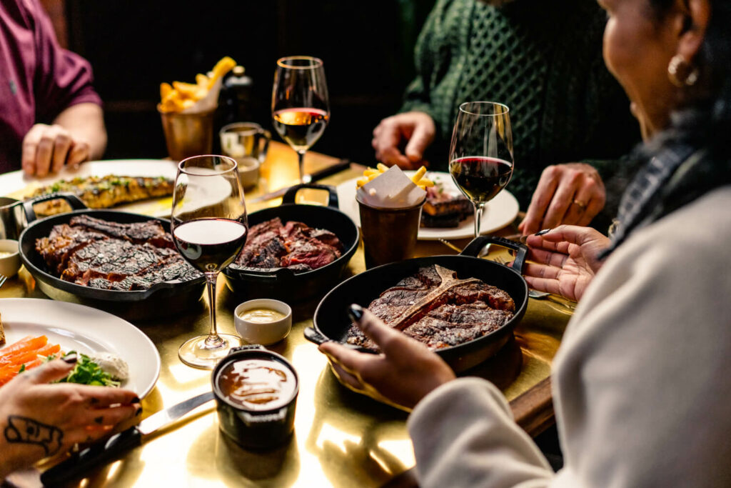 Hawksmoor Beefsteak Club showing the table laid out with steak dishes