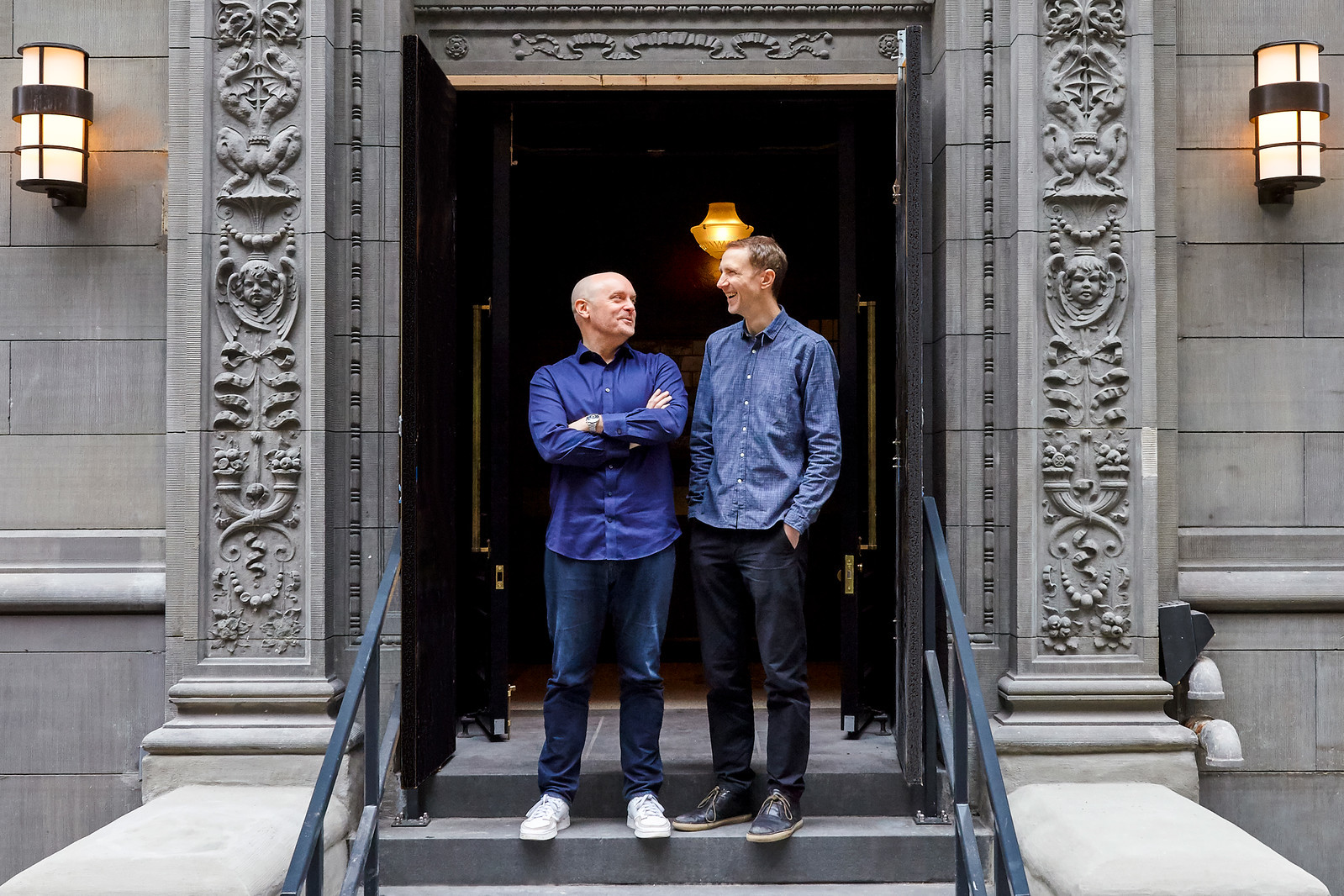 Founder Will and Huw stood outside Hawksmoor New York smiling at each other