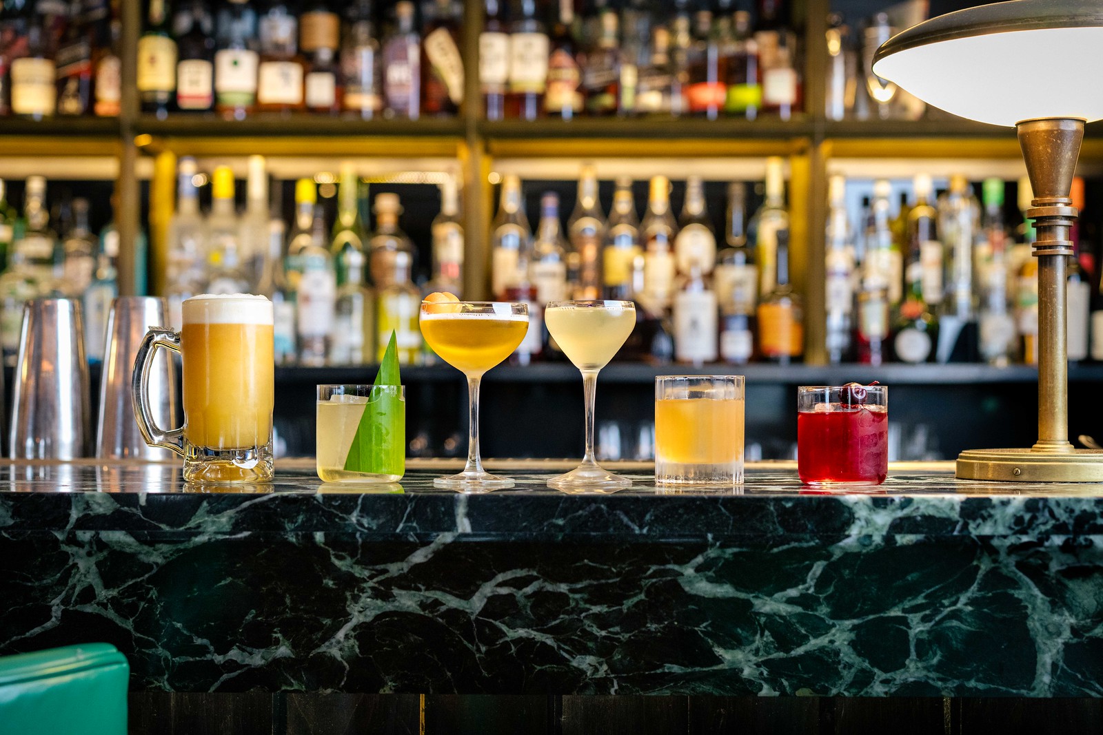 Hawksmoor's Sacred Six - six signature cockatils in a line up shot on a bar top