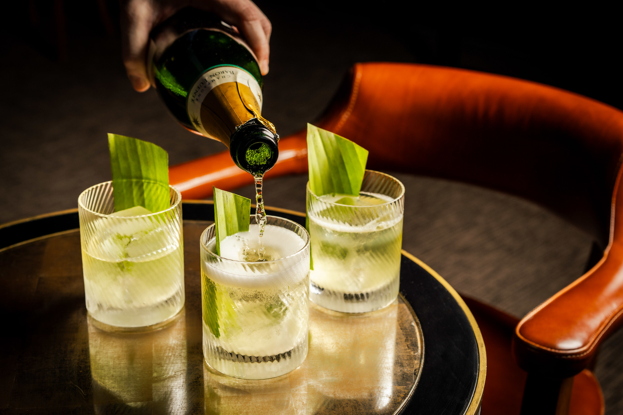 hree cocktails in tumbler, garnished with green stalks