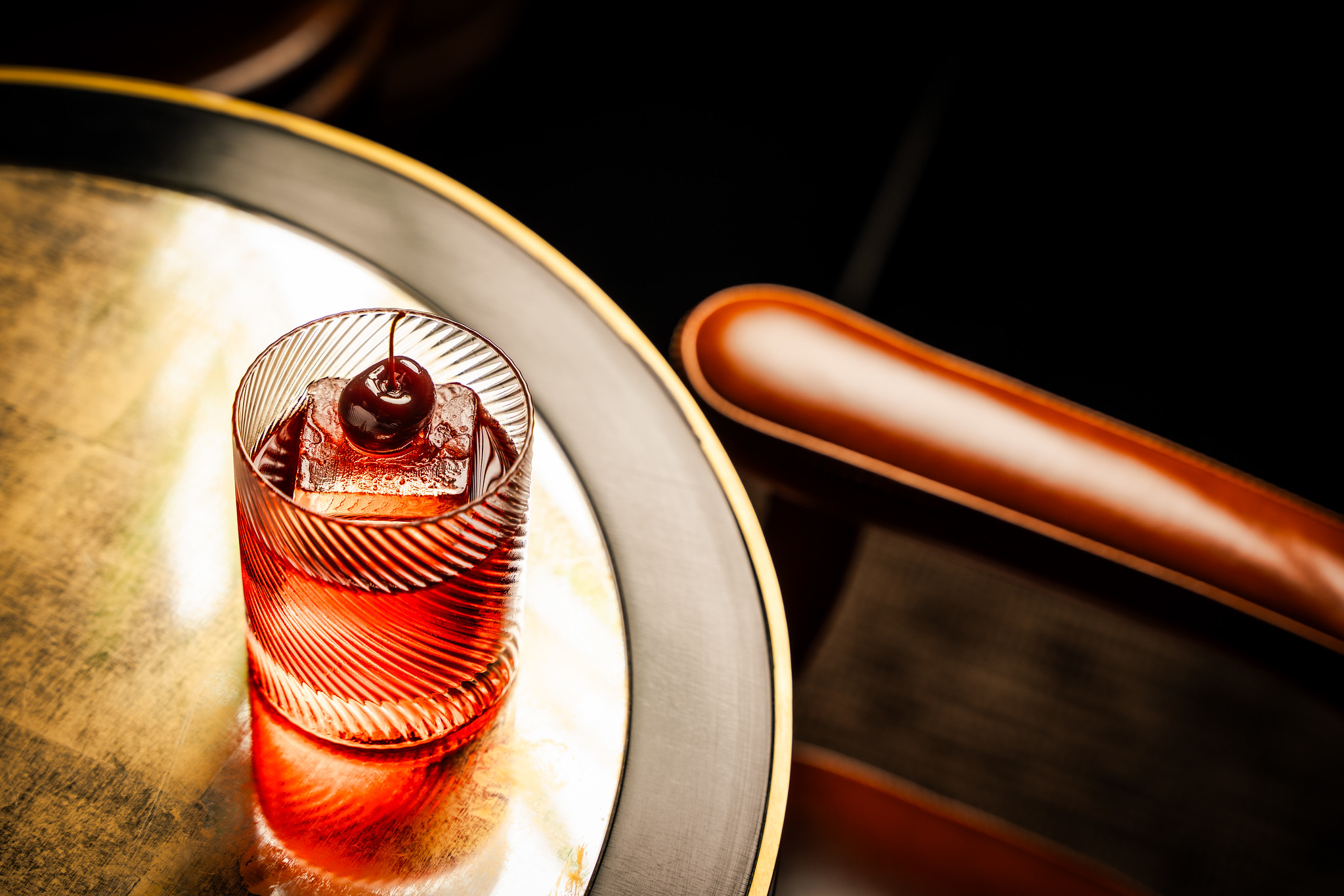 negroni cocktail shot on a round cocktail table