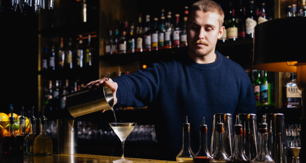 Cocktails 3 Bar tender pouring the Hawksmoor Dawn & Dusk Martini at Hawksmoor Chicago River North.