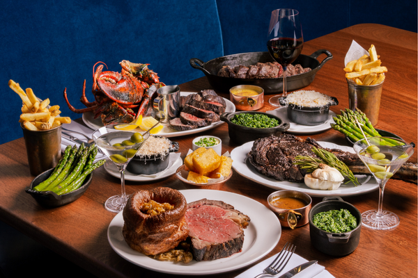 Table spread of steaks and sides