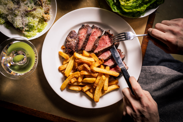 Rump steak and chips on a white plate