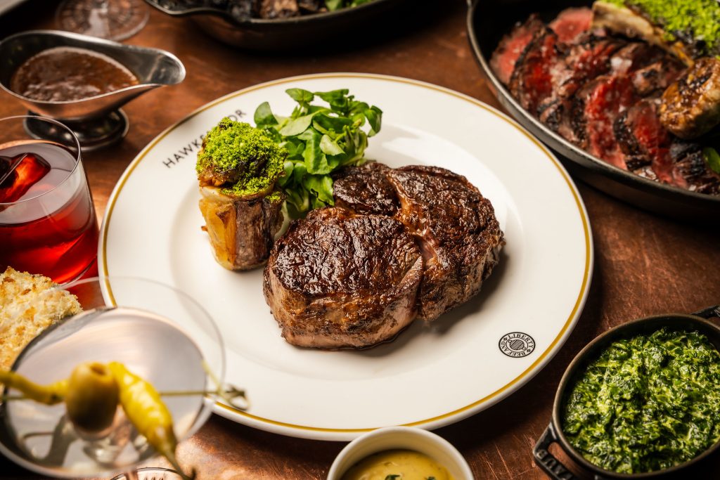 Rib-eye steak with a steakhouse salad on a white plate