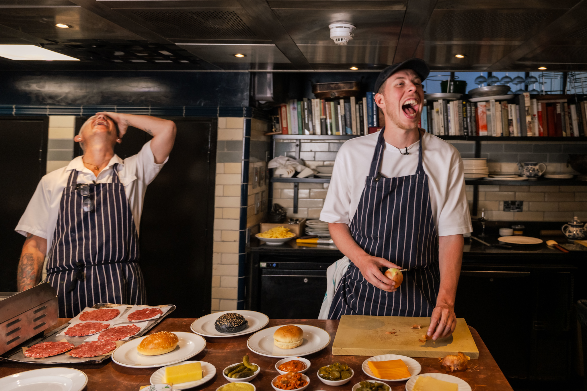Chef Matt and Calfrezzy laughing while working on the Burgurr build