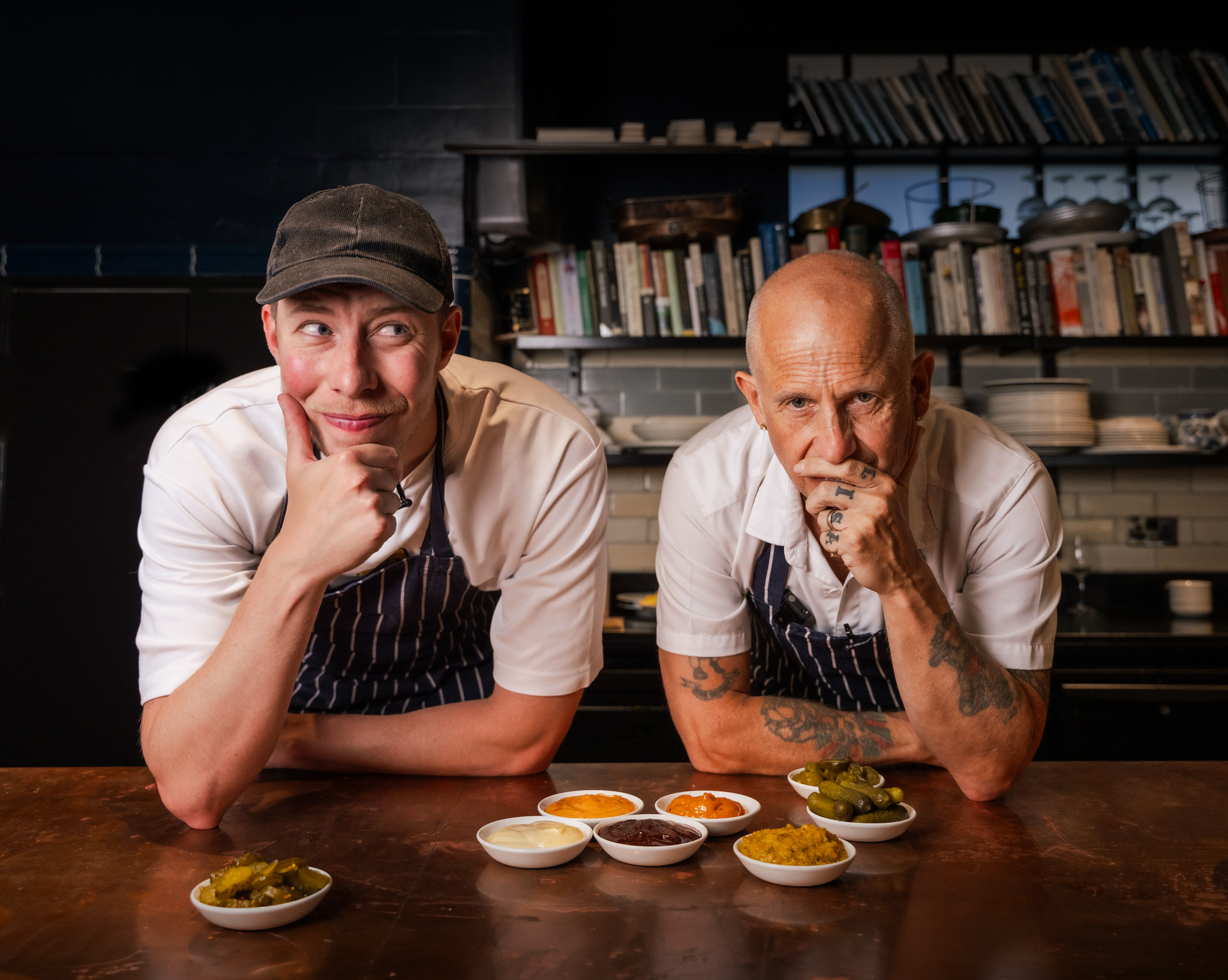 Calfreezy and Chef Matt, pictured leaning over the table with thoughtful expressions on their faces
